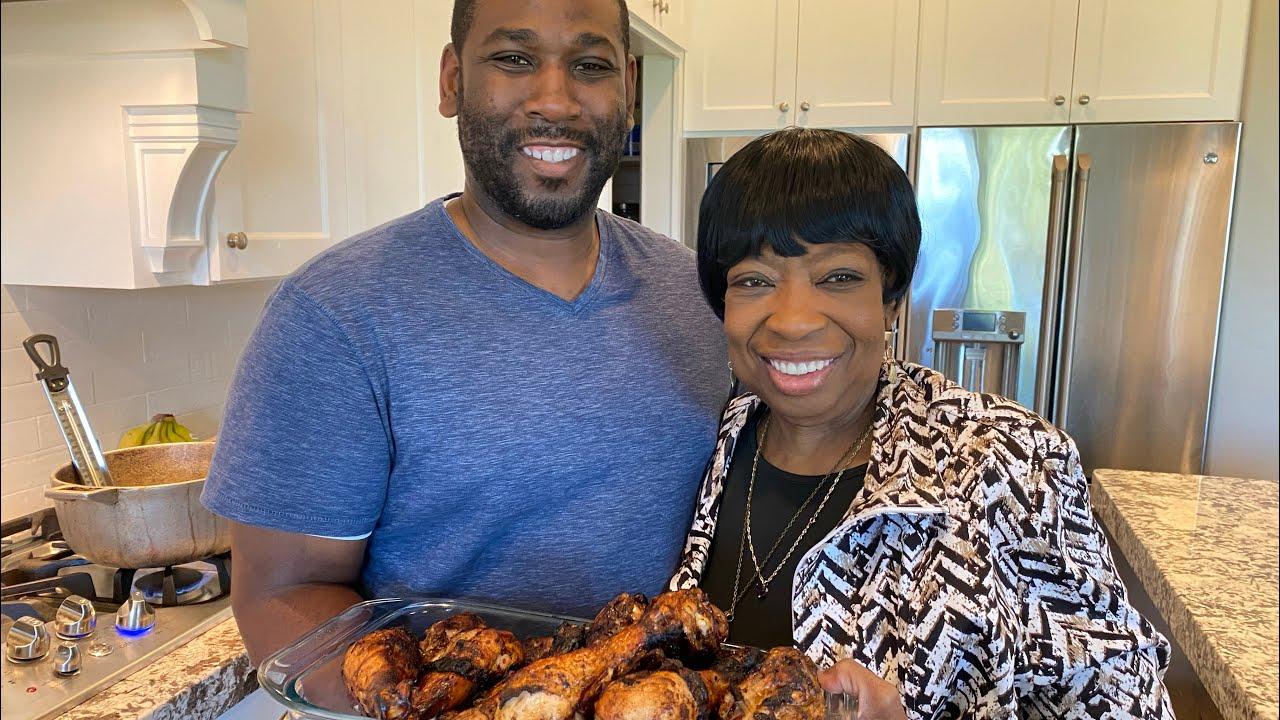 grandmother teaching grandson how to cook jerk chicken