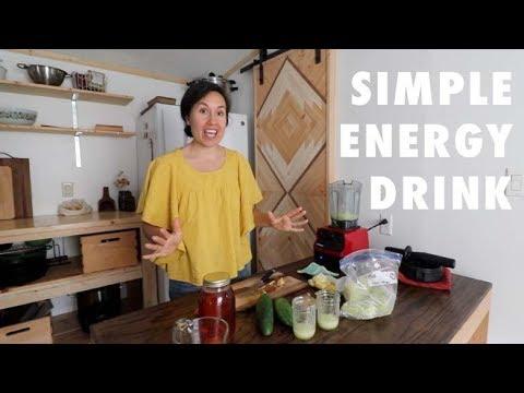 person blending ingredients for homemade energy nectar in a kitchen