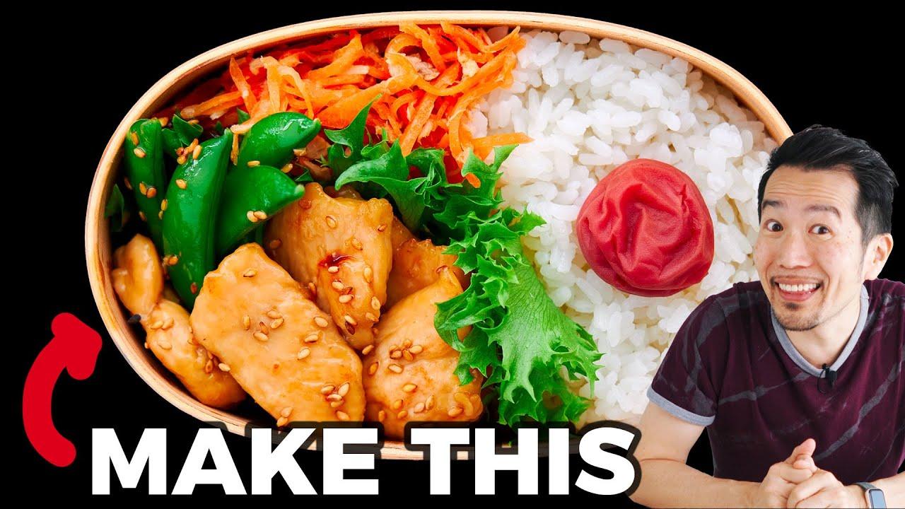Overhead shot of a person assembling a teriyaki chicken and broccoli rice bowl bento box