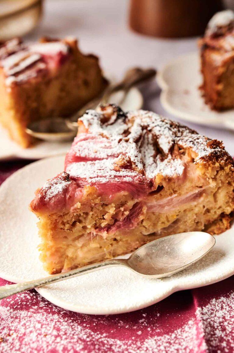 Slices of rhubarb and macadamia cake arranged beautifully on a plate