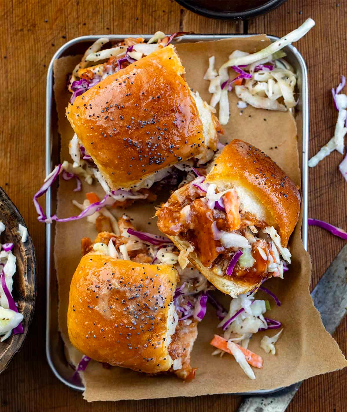 Georgia Peach BBQ Pulled Pork Sliders on a wooden board with peach slices