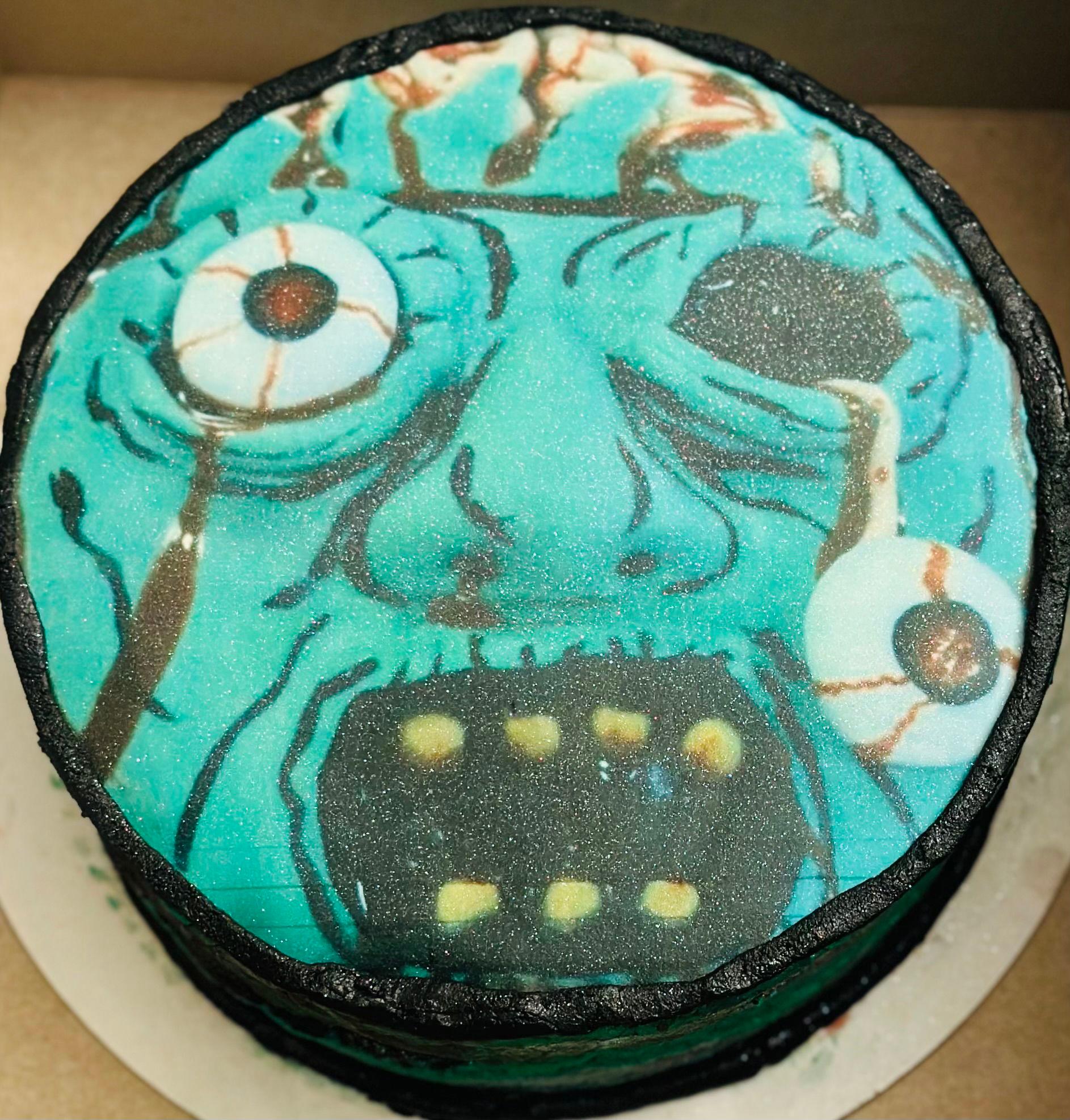 a slice of chocolate zombie cake on a plate, with visible layers of chocolate cake and green frosting