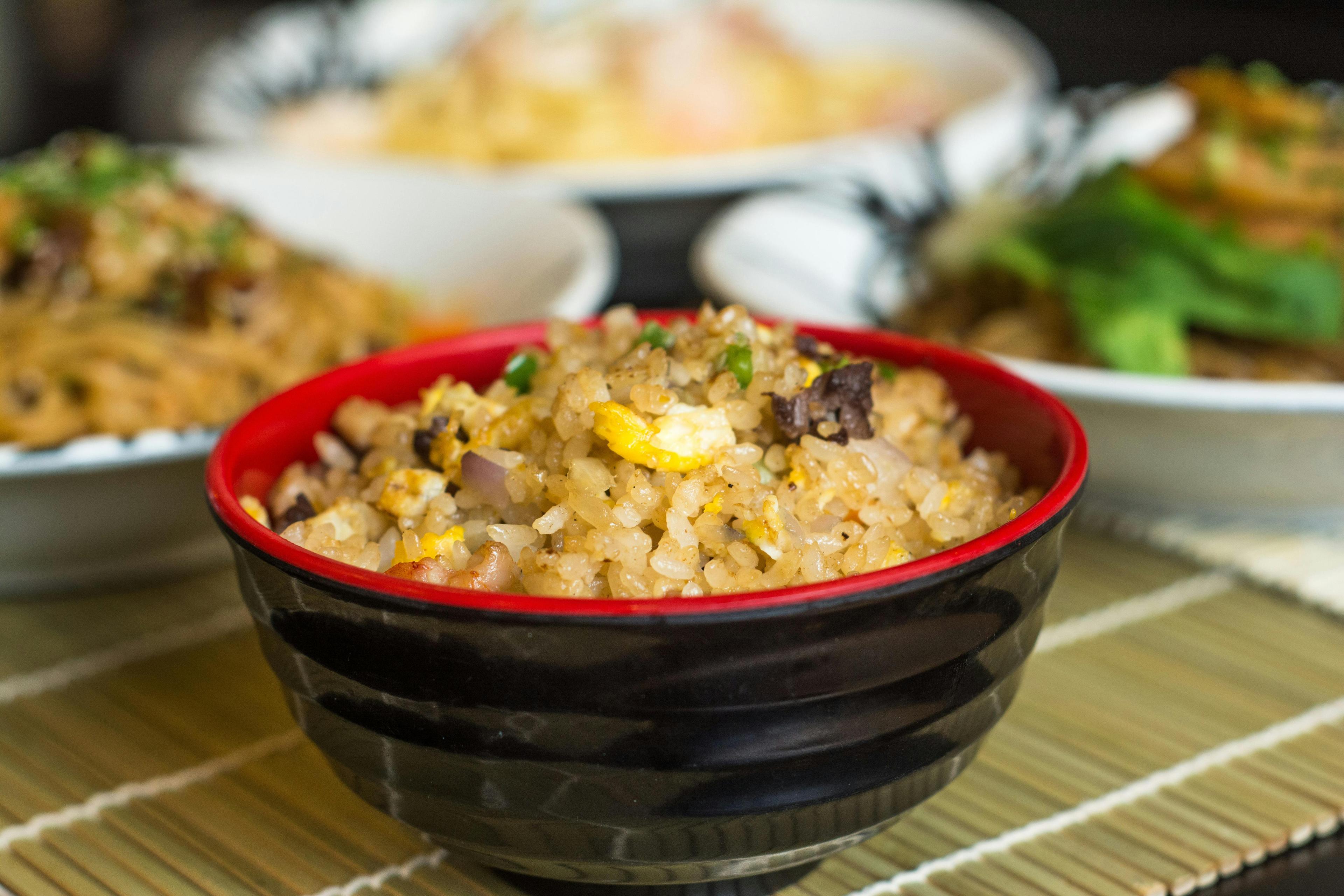 Overhead shot of Dutch stamppot fried rice in a colorful bowl, garnished with fresh herbs