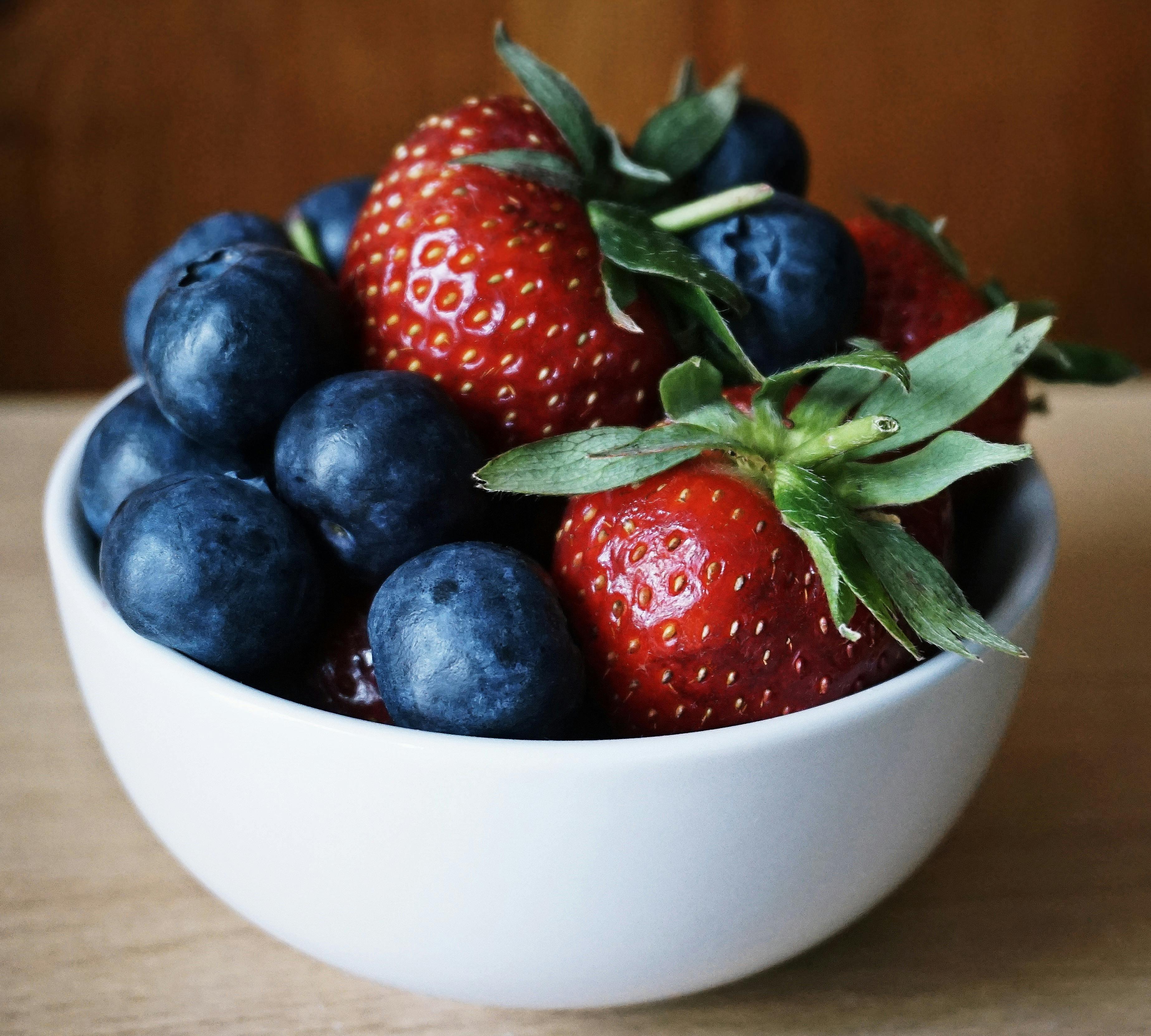 close-up shot of vibrant, colorful berries in a bowl
