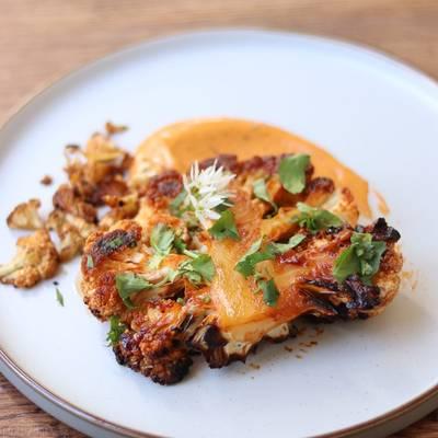 Gochujang glazed cauliflower steaks on a baking sheet