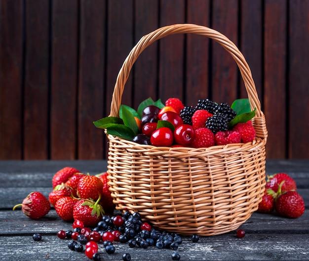 Fresh blackberries and rhubarb in a rustic basket