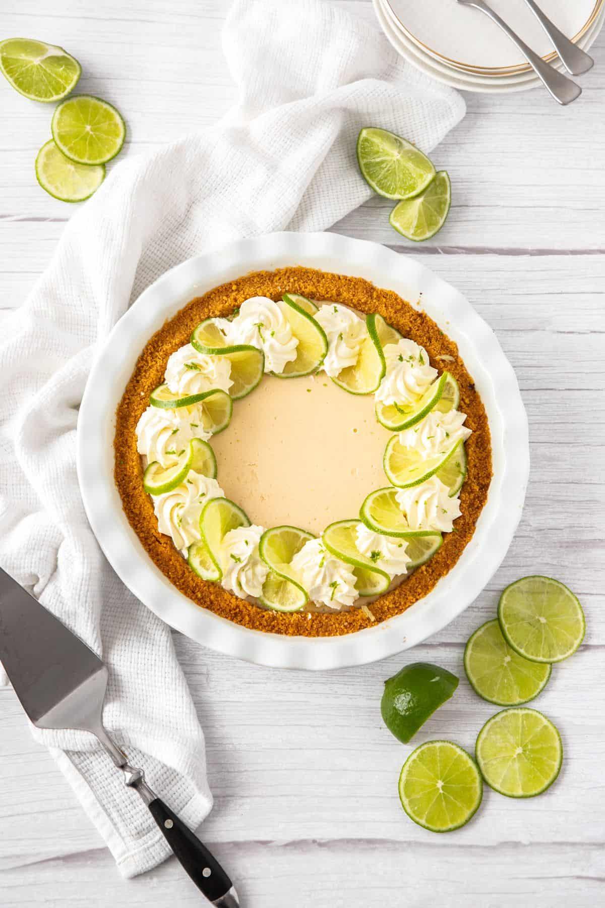 overhead shot of a key lime cake being sliced with a knife