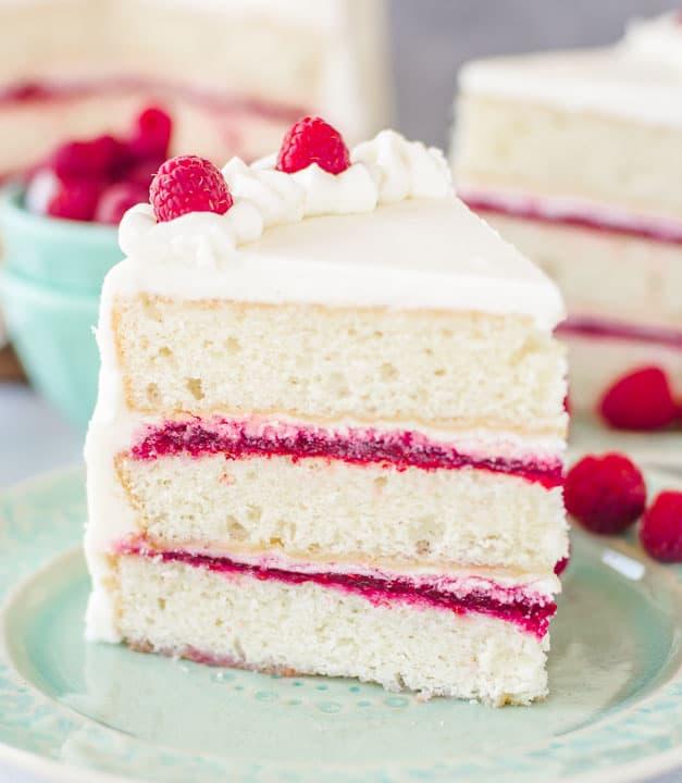 slice of white chocolate raspberry cake with fresh raspberries
