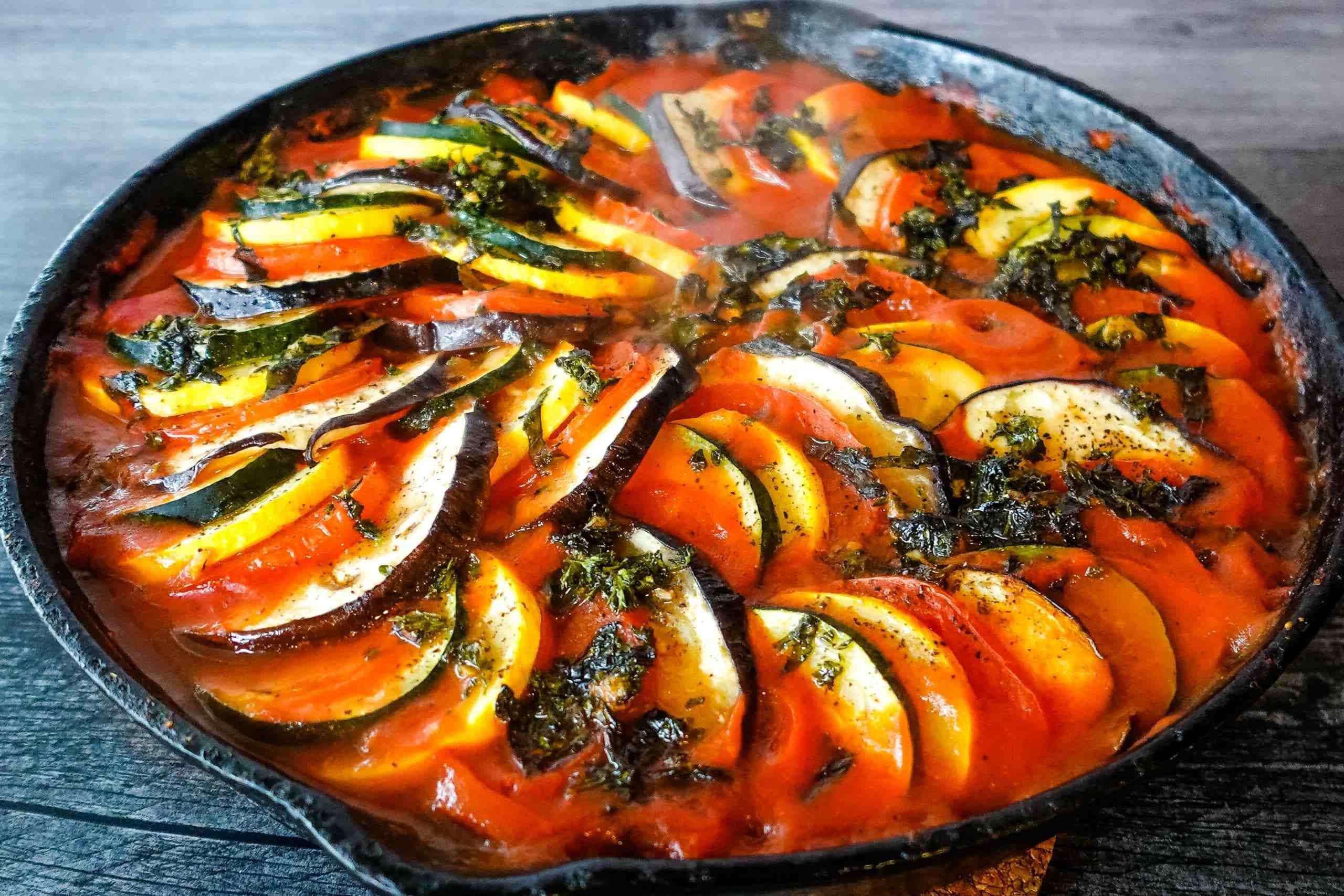 A vibrant Summer Ratatouille Breakfast Bake in a baking dish, showcasing colorful vegetables and golden-brown cheese.