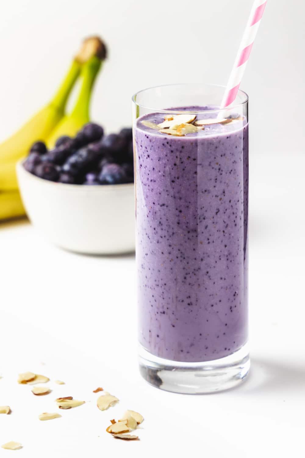 glass of blueberry almond cold brew garnished with fresh blueberries and almonds