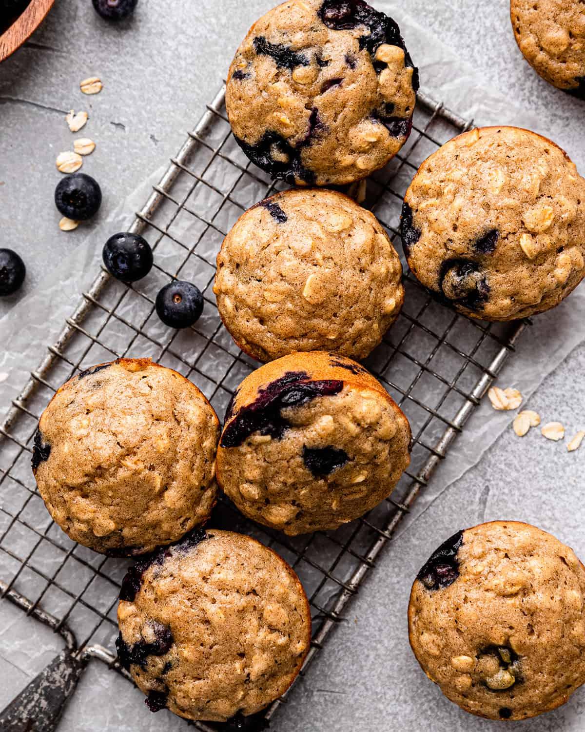 overhead shot of a batch of blueberry oat muffins cooling on a wire rack