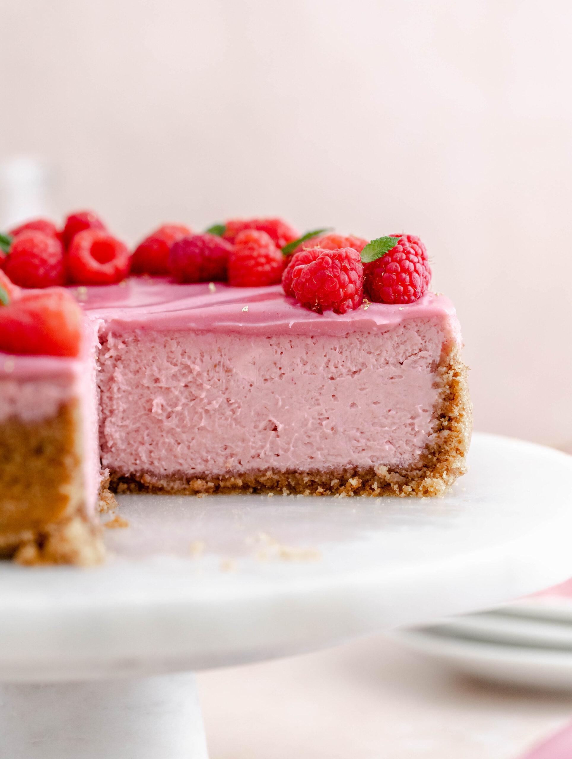 Close-up shot of a slice of Valentine's Raspberry Rose Cheesecake, showing the layers and textures