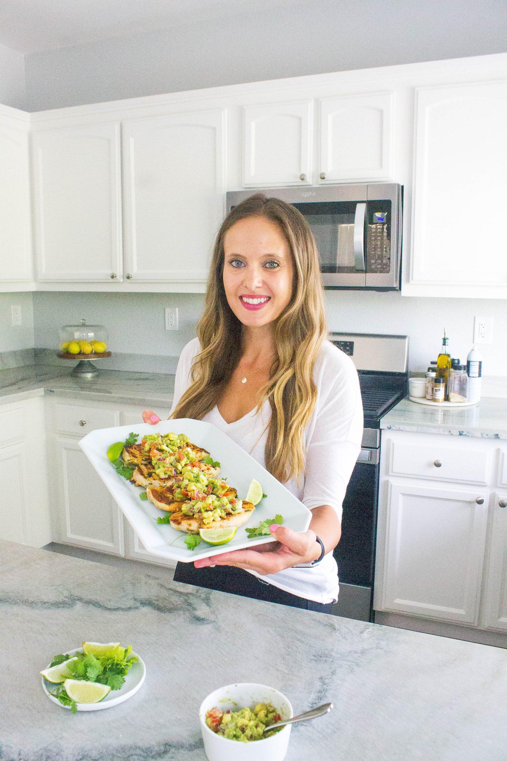woman preparing cilantro lime chicken bowl in kitchen