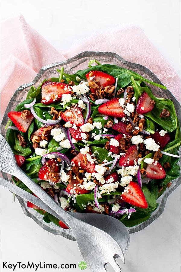 overhead view of a person assembling the strawberry feta lime salad
