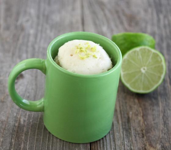 coconut lime mug cake being stirred in a mug