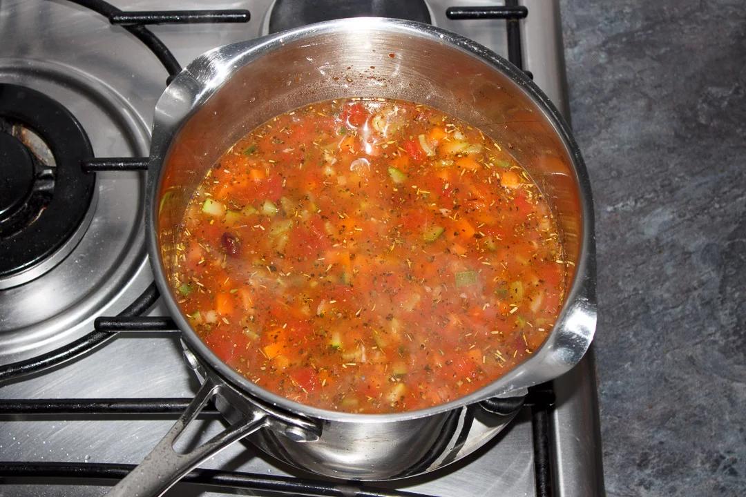 a pot of minestrone simmering on a stove