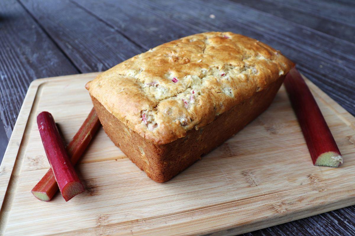 freshly baked buttermilk rhubarb quick bread sliced on a wooden board