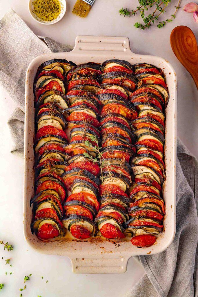 Slices of zucchini and tomatoes arranged in a baking dish