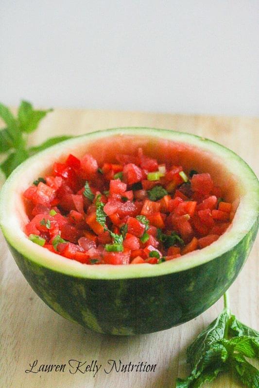 close-up shot of watermelon salsa in a colorful bowl, garnished with mint