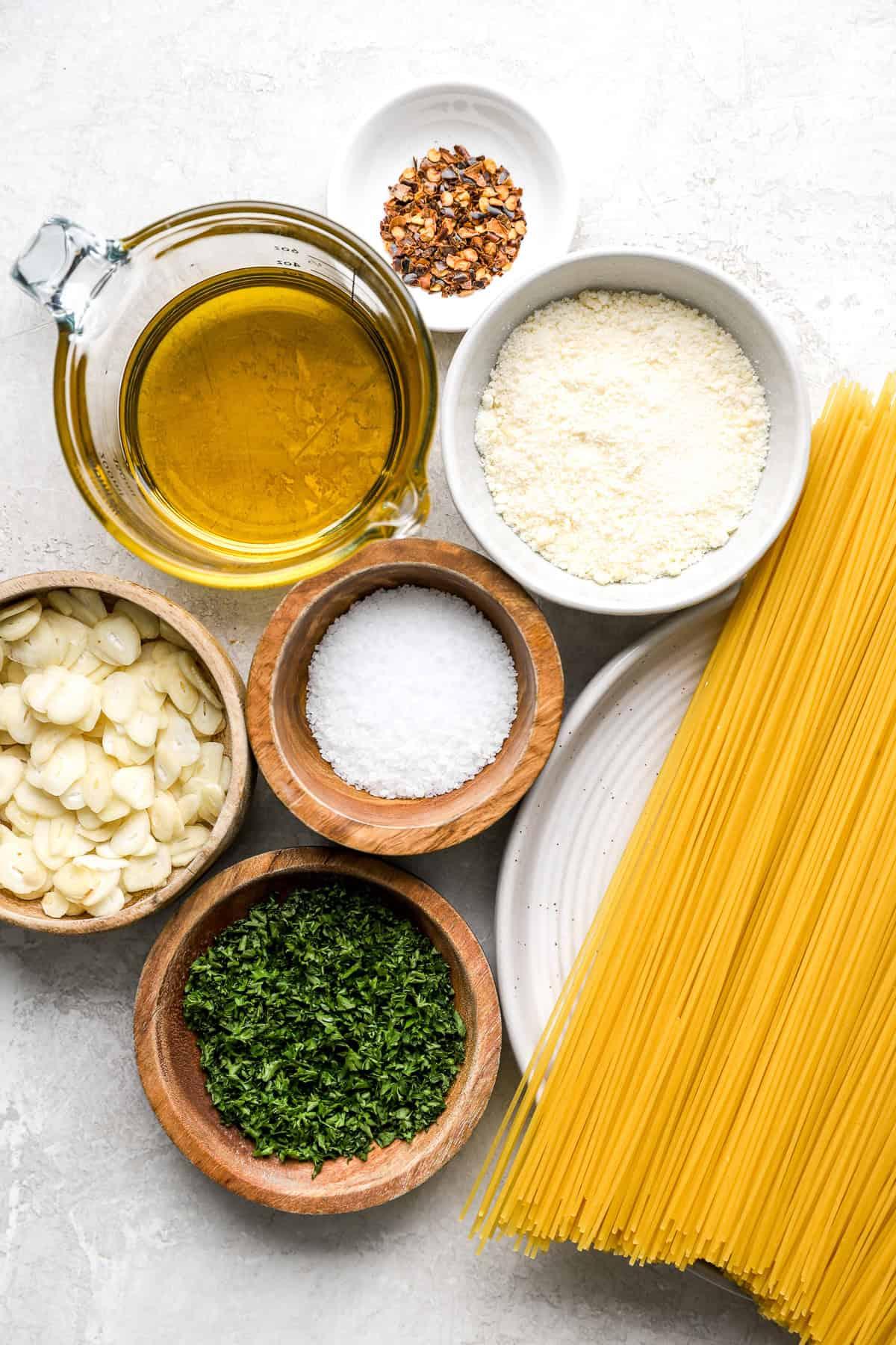 spaghetti aglio e olio ingredients laid out on a wooden table