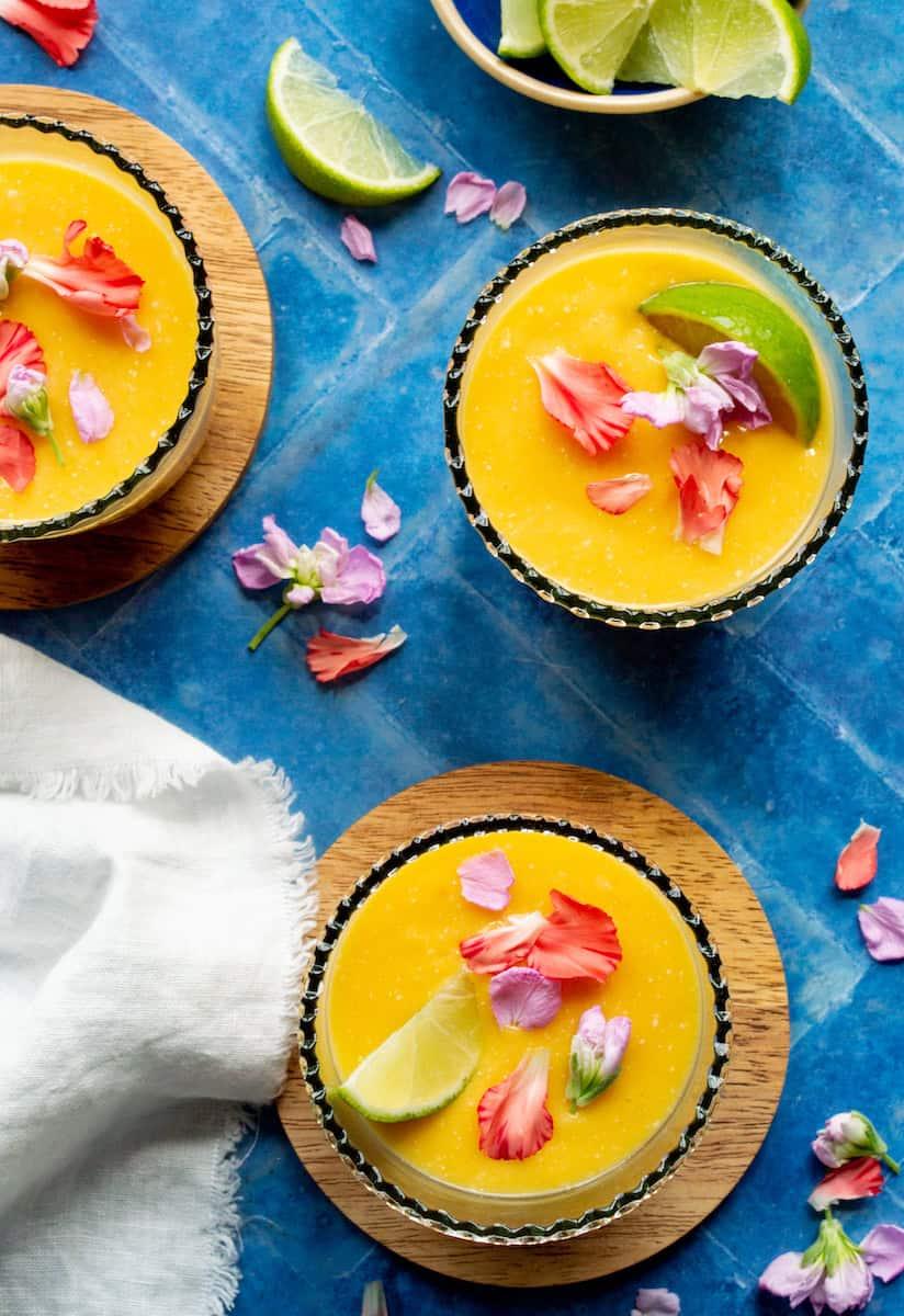 close-up shot of a glass filled with coconut mango mirage, garnished with a lime wedge