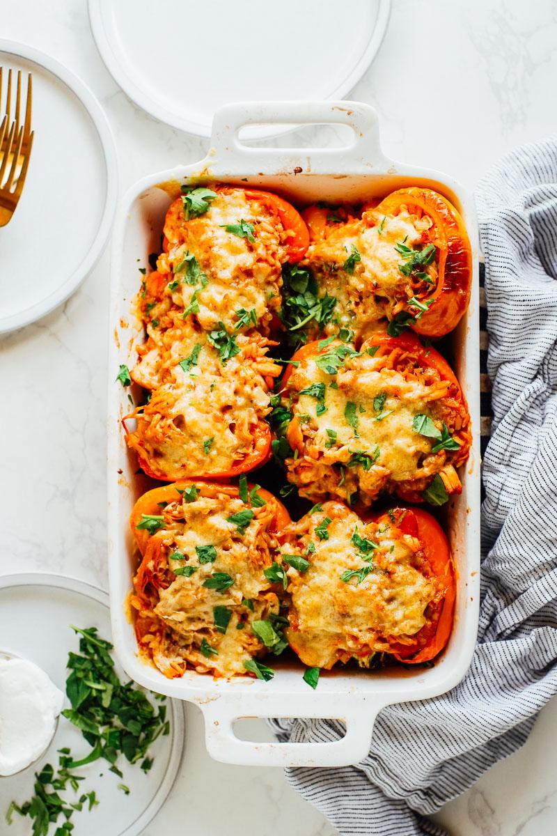 family enjoying buffalo cauliflower stuffed peppers at a dinner table