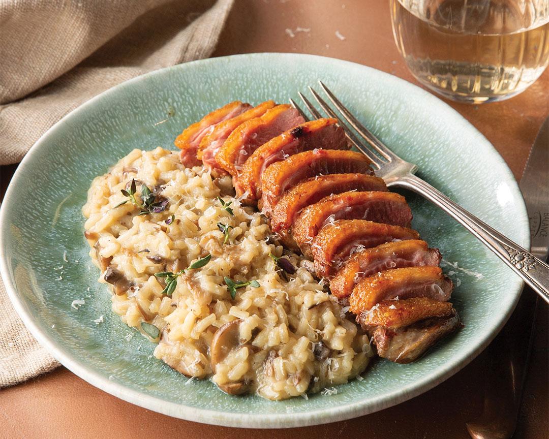 Finished duck and cherry risotto garnished with thyme.