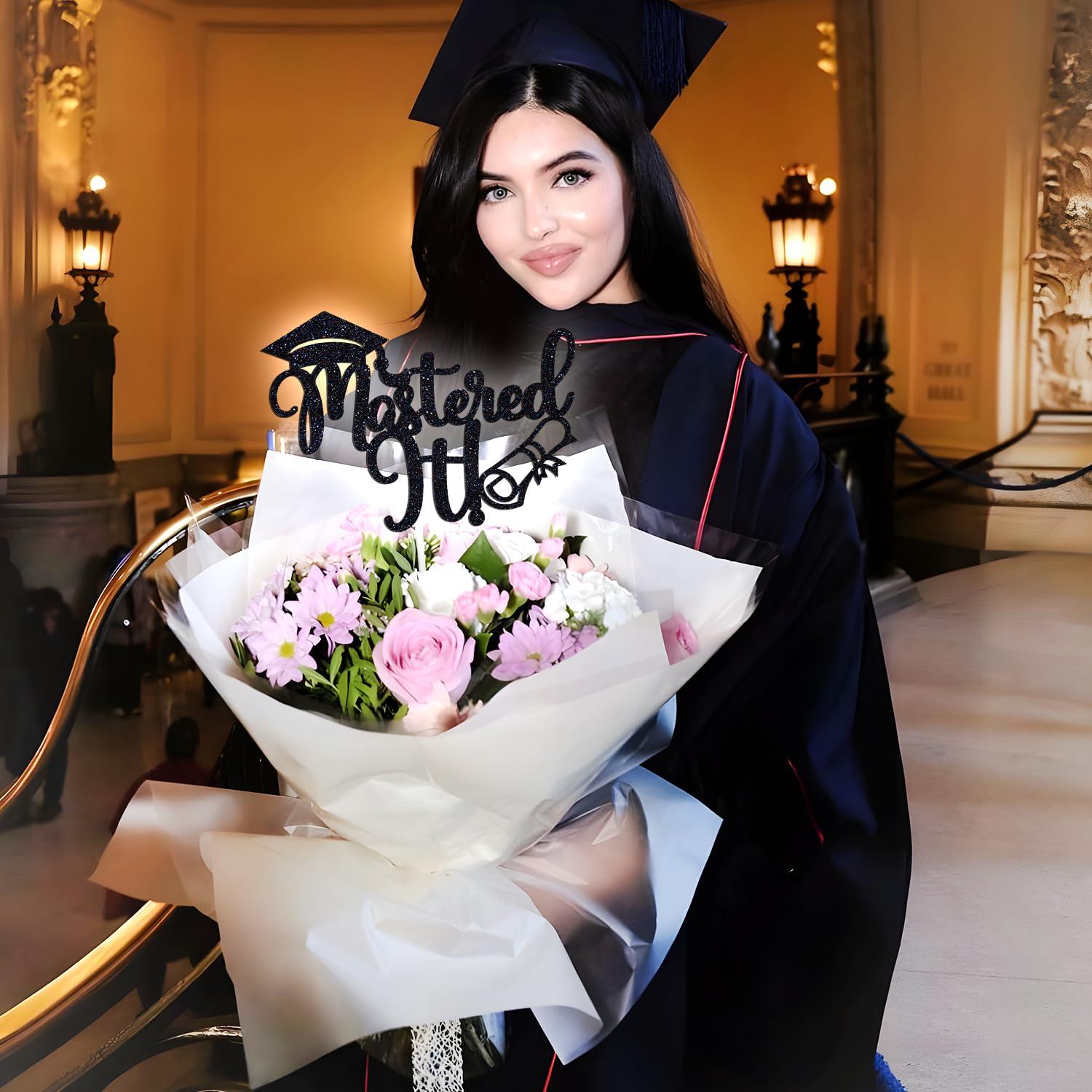 a graduation gown cake being presented to a smiling graduate