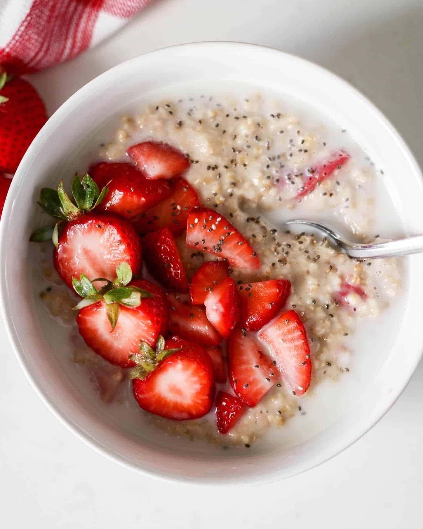 close-up of strawberry oatmeal with sesame seeds and chopsticks