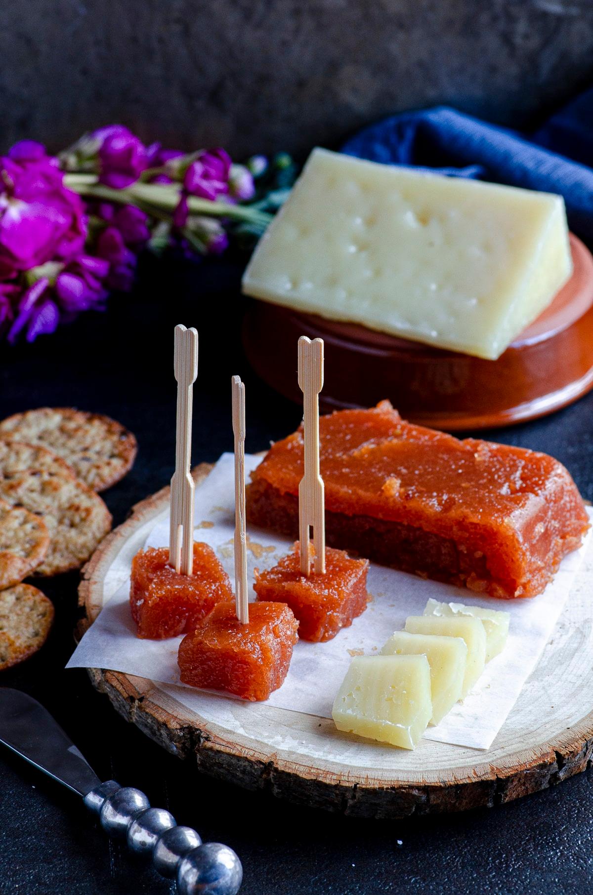 grandmother serving quince paste with cheese