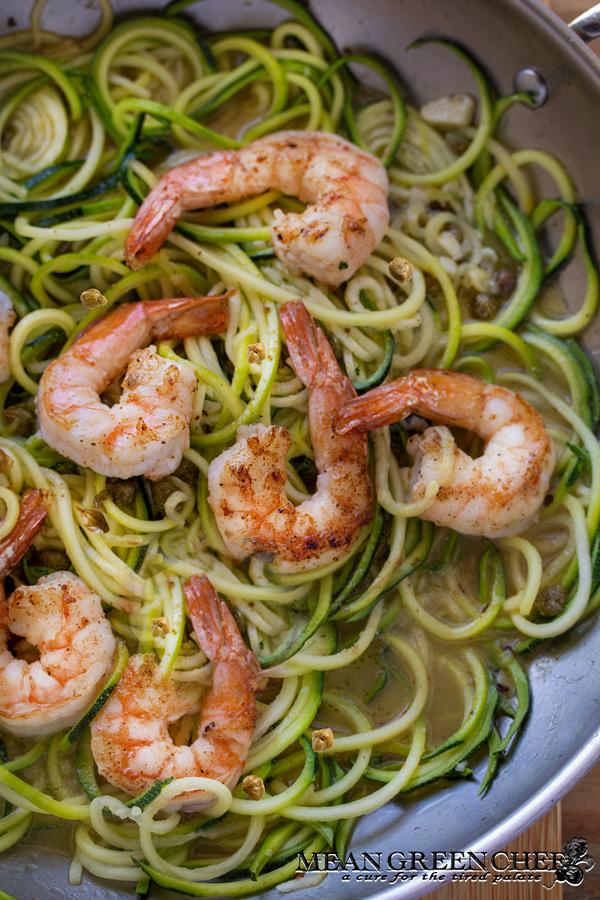 Close-up shot of shrimp scampi with zucchini noodles in a skillet