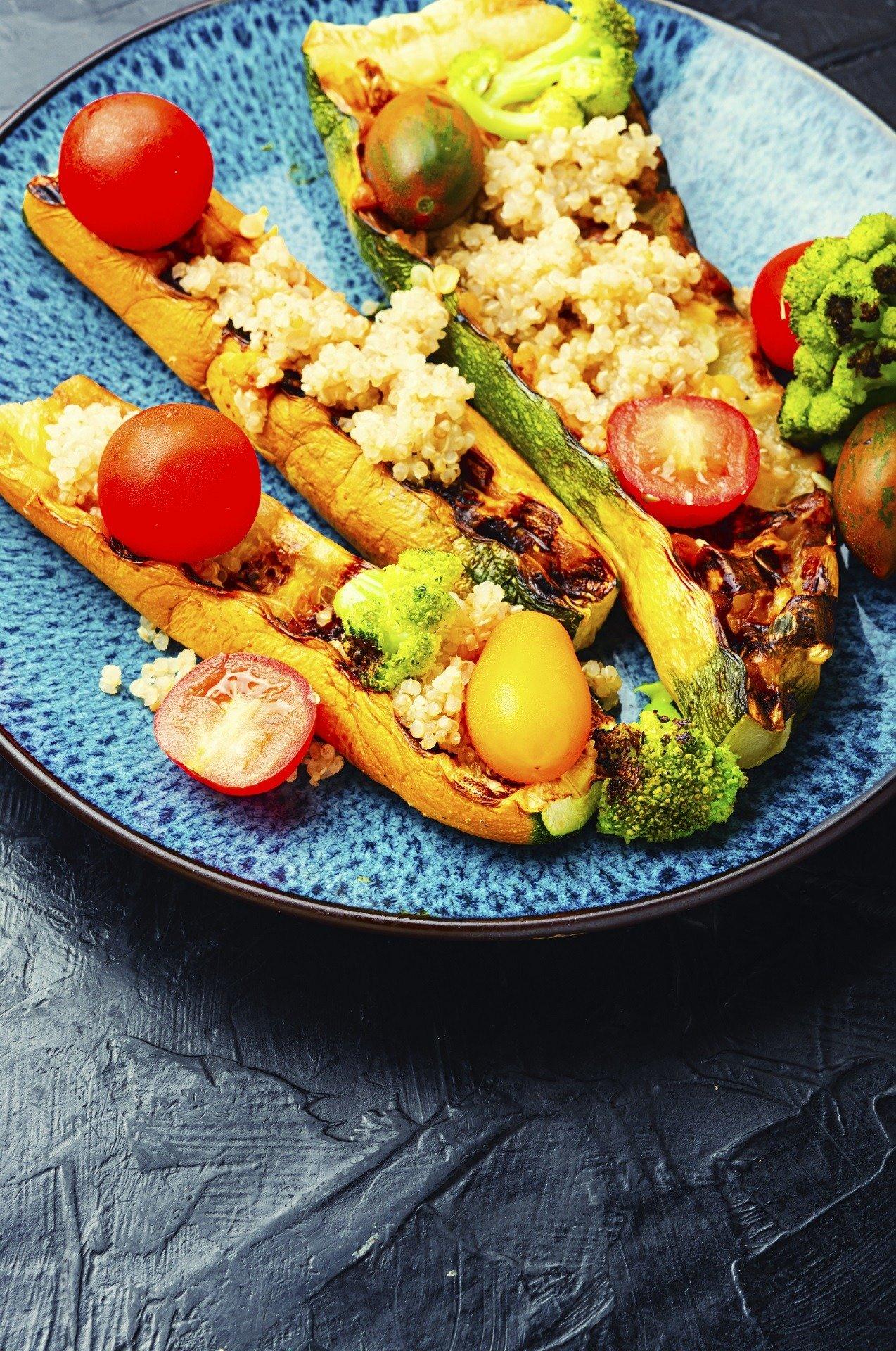 overhead shot of baked Quinoa and Broccoli Stuffed Zucchini on a baking sheet