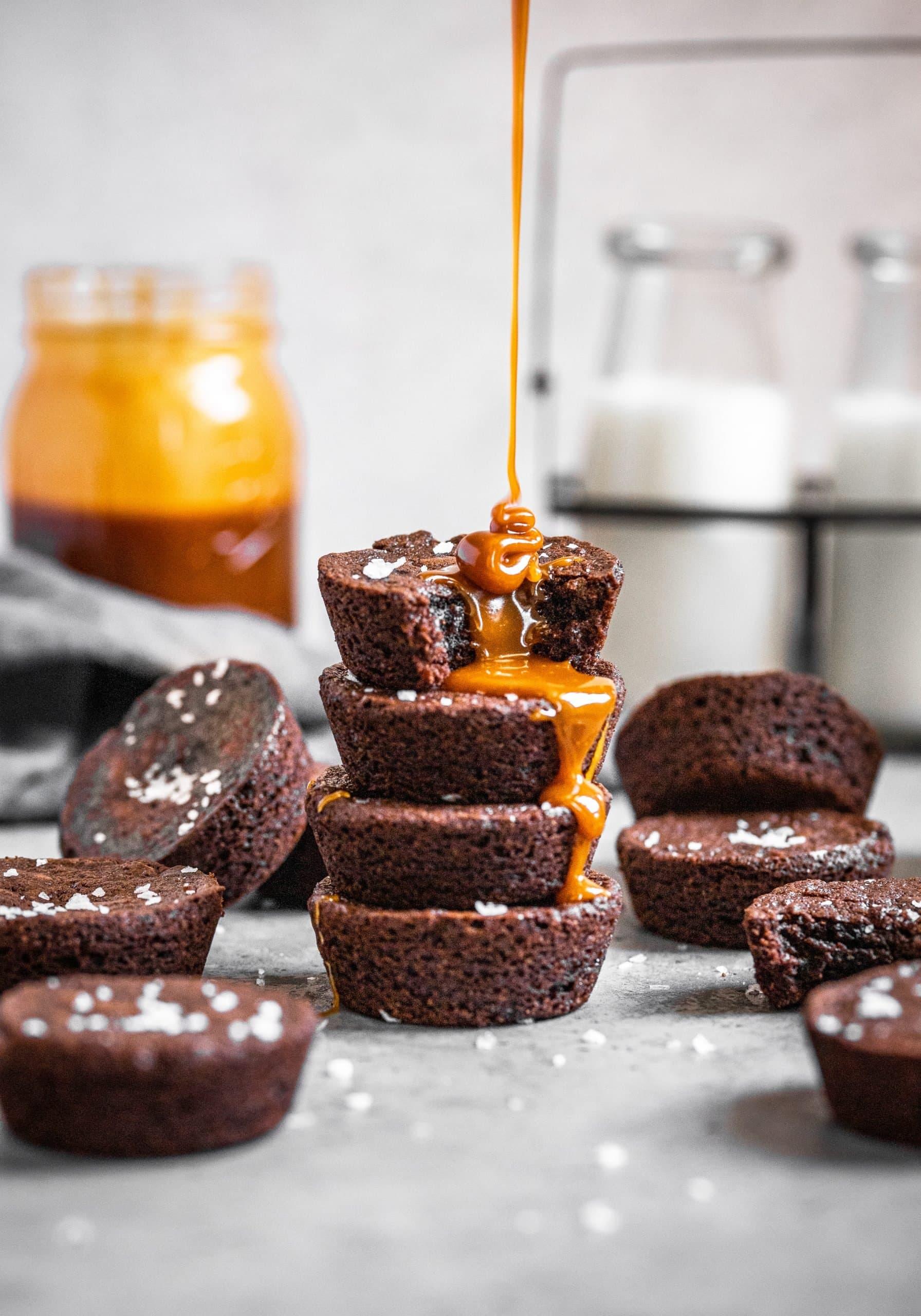 salted caramel being drizzled on top of brownie bites