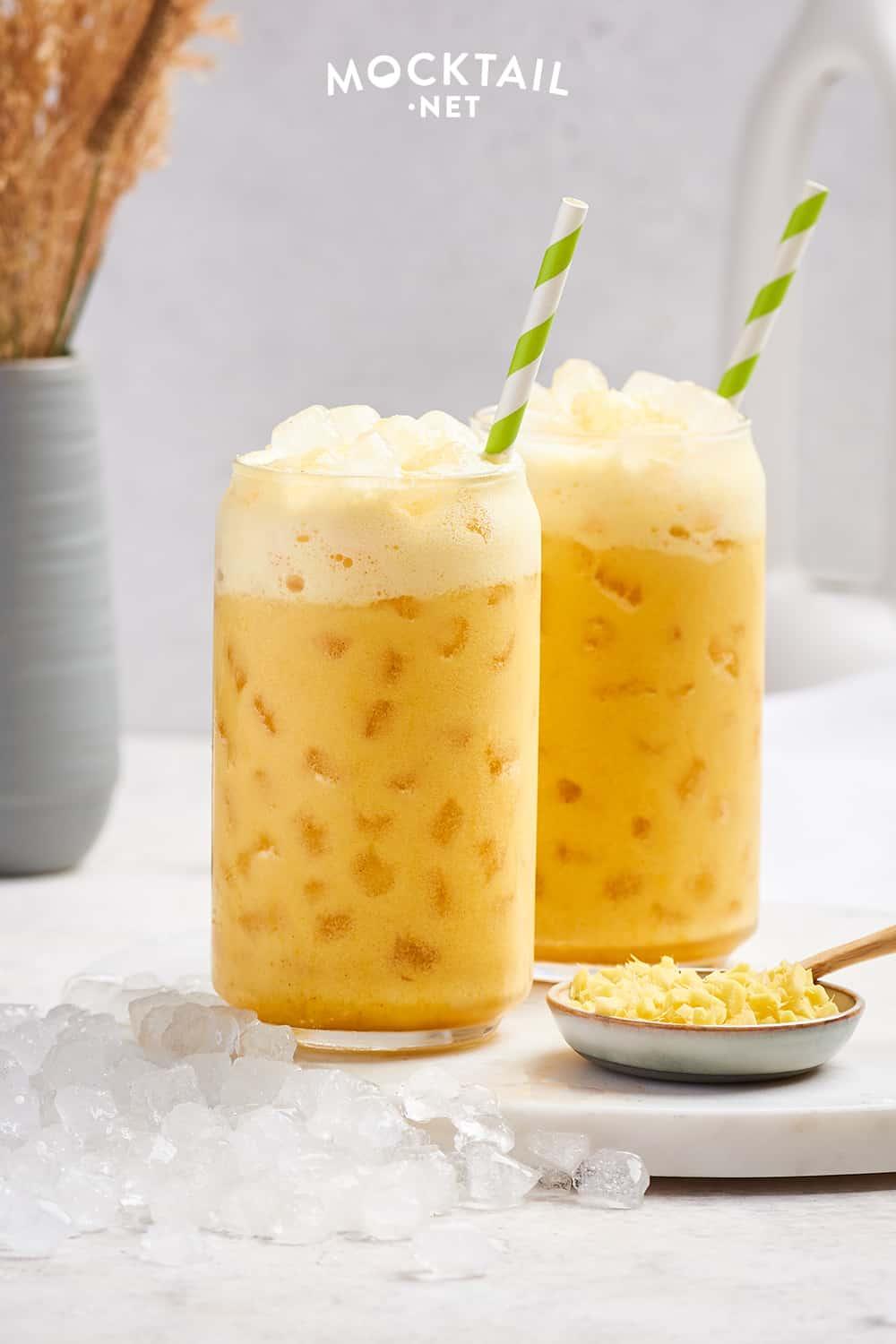pitcher of iced golden ginger drink with ginger root