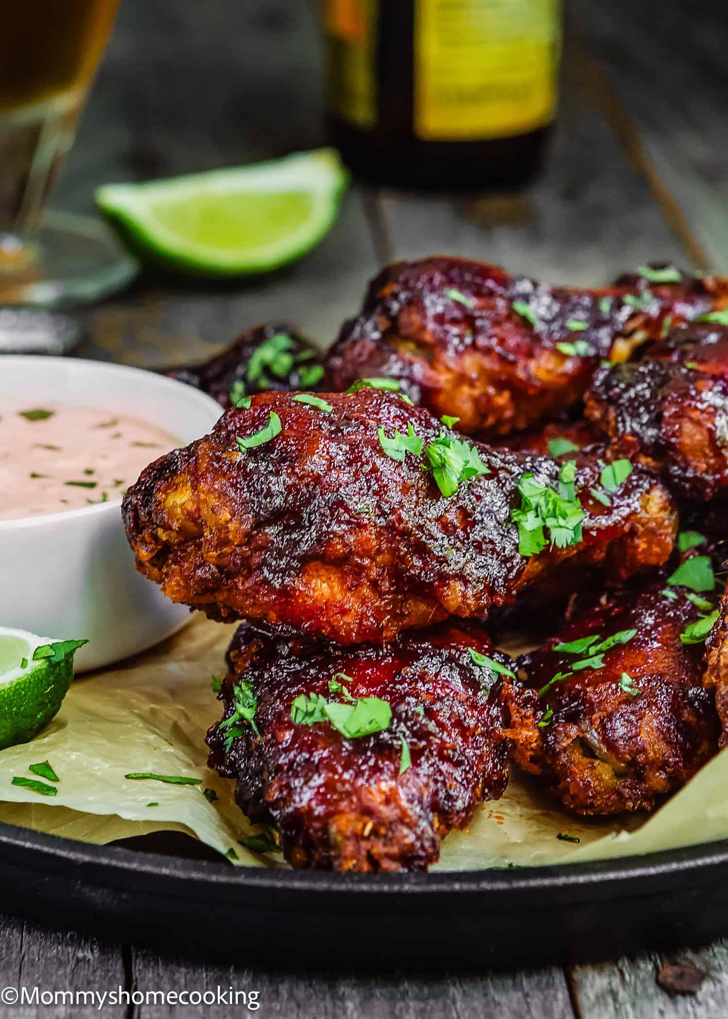 A platter of freshly grilled brown sugar-chipotle chicken wings garnished with cilantro