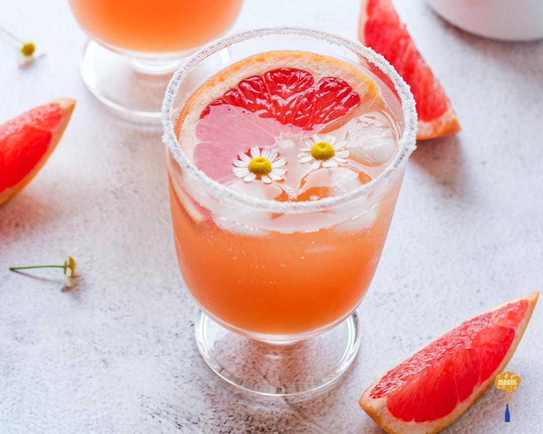 a glass of grapefruit lemonade with a honeycomb on a bright sunny day