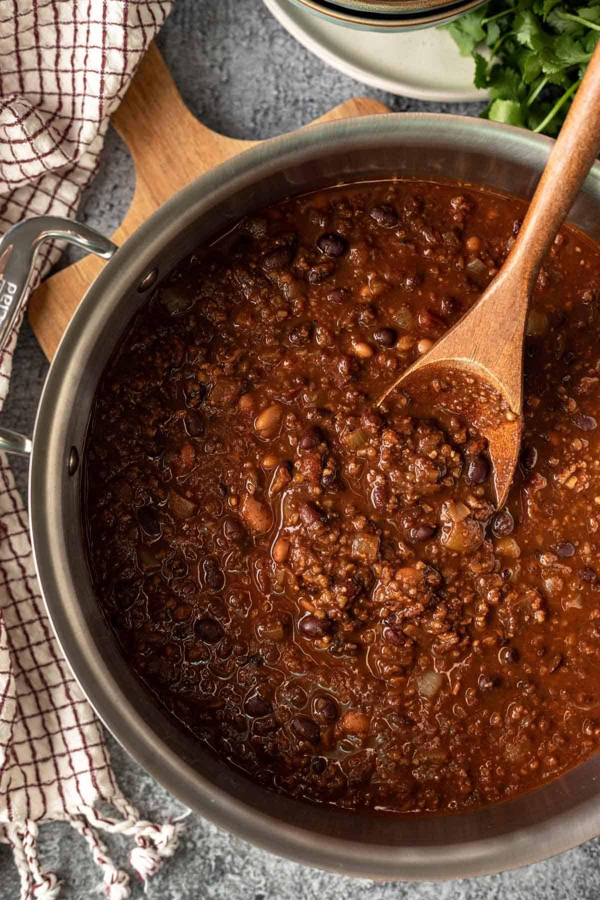 close-up of walnuts being added to the chili