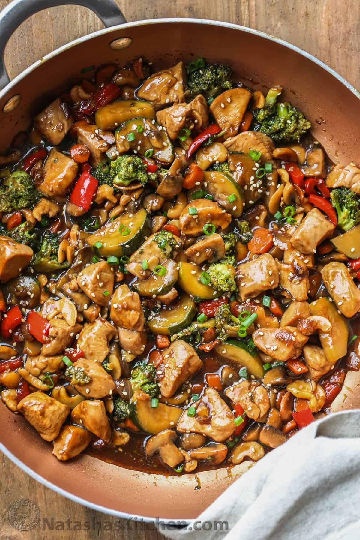 close-up of ginger soy chicken stir-fry being cooked in a wok