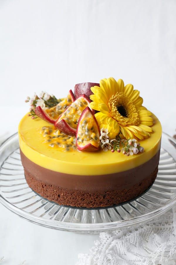 whole pineapple passion chocolate layer cake on a decorative cake stand