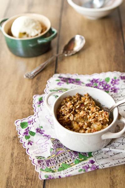 a slice of cardamom pear crisp with toasted almonds being served
