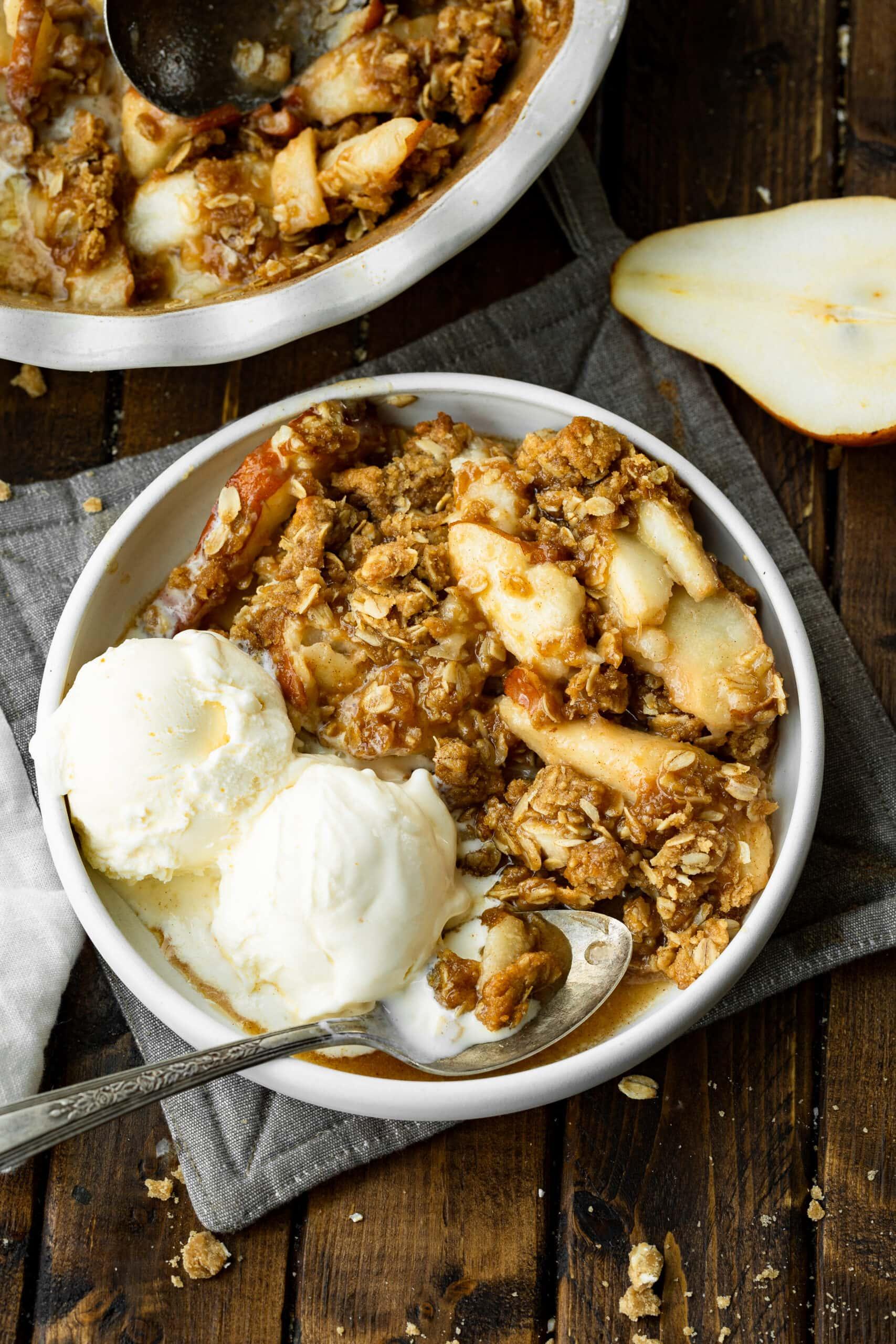 golden lemon pear crisp with coconut streusel topping, served warm in a baking dish