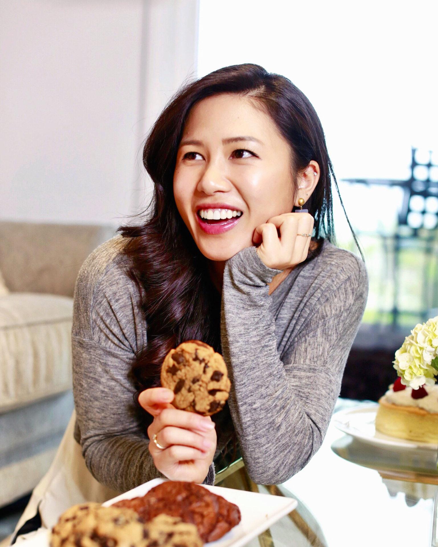 woman happily baking matcha cookies in her kitchen