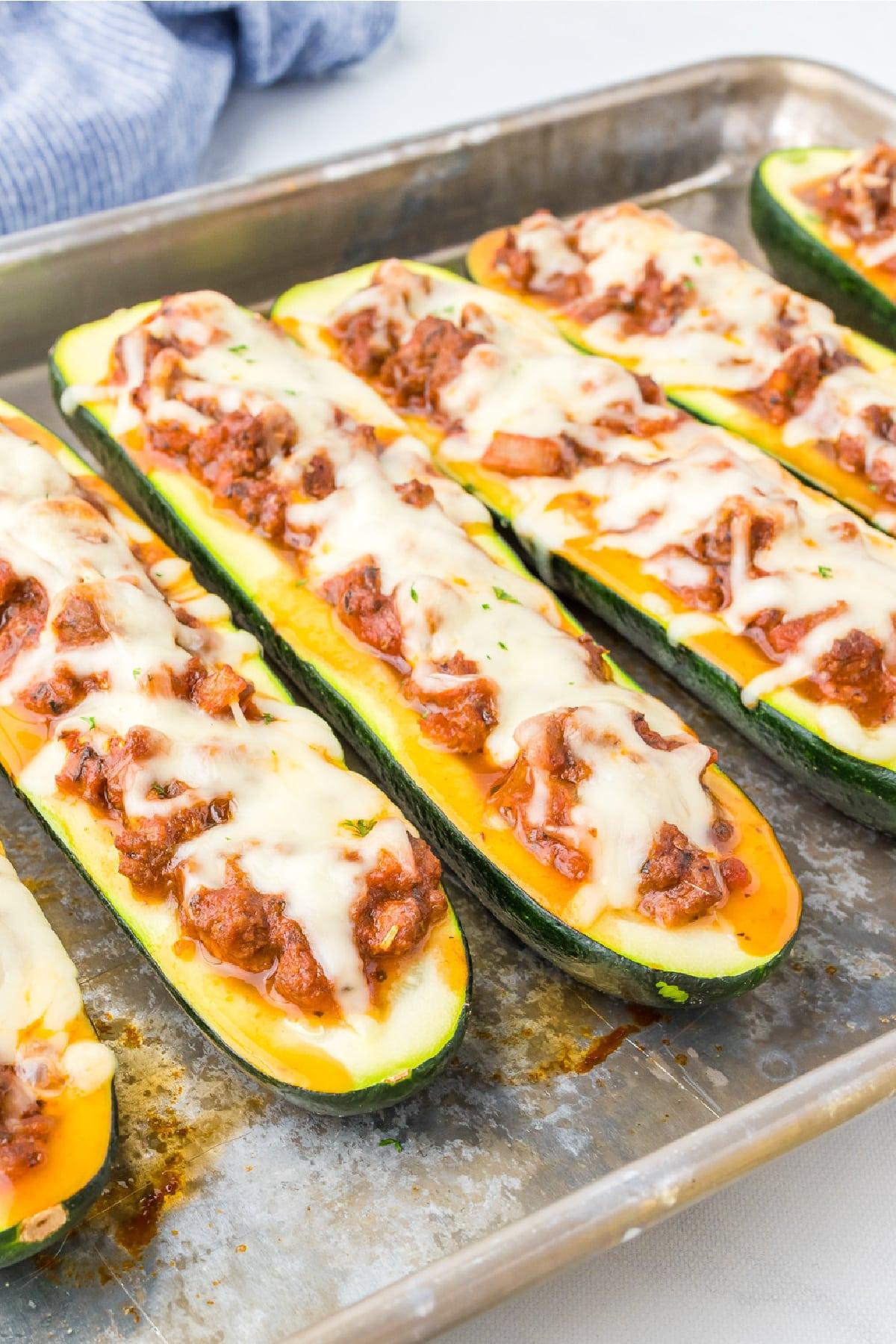 Close-up of stuffed zucchini halves in a baking dish
