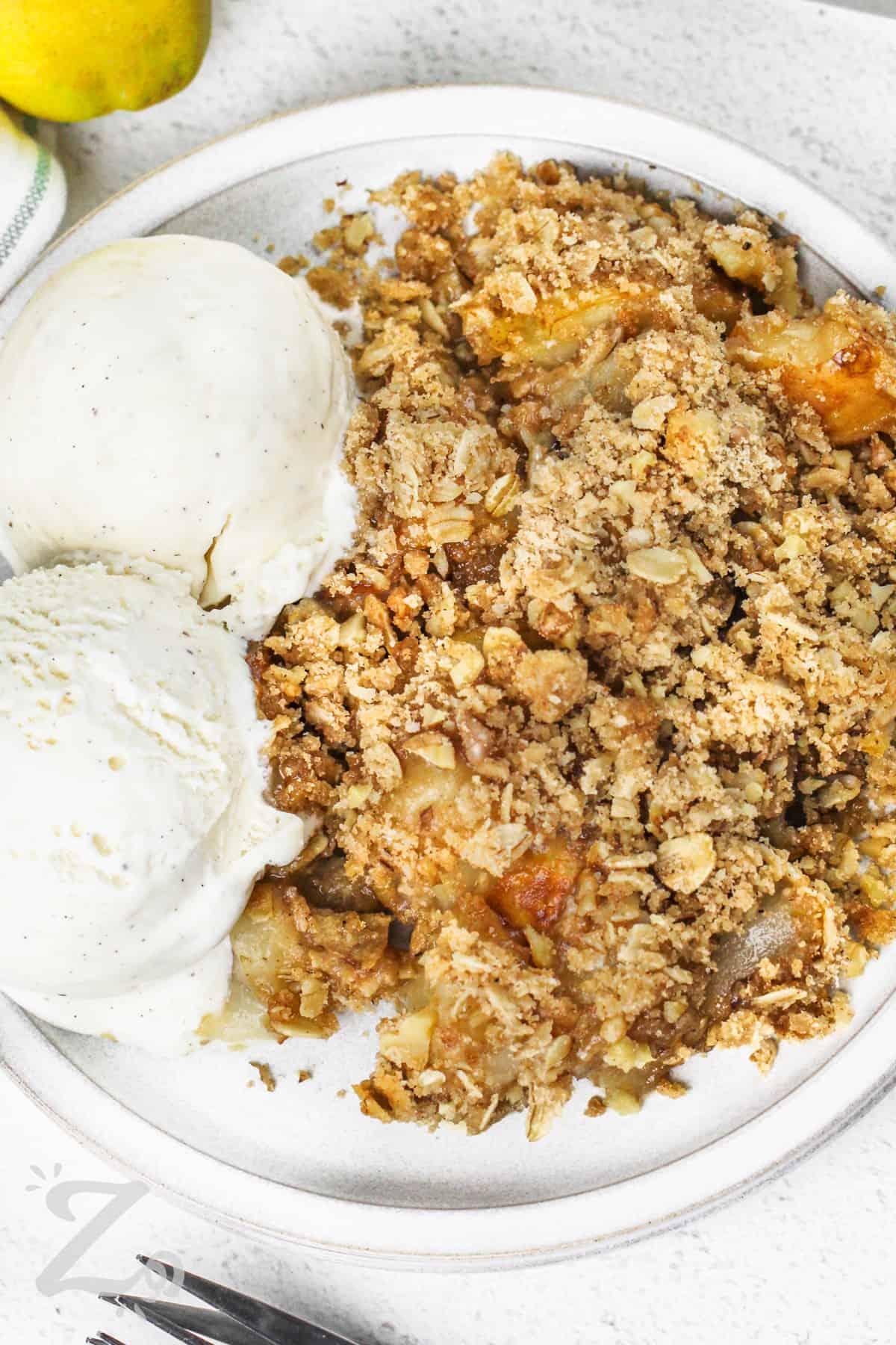 golden brown oat crumble topping with hemp seeds on a pear crisp