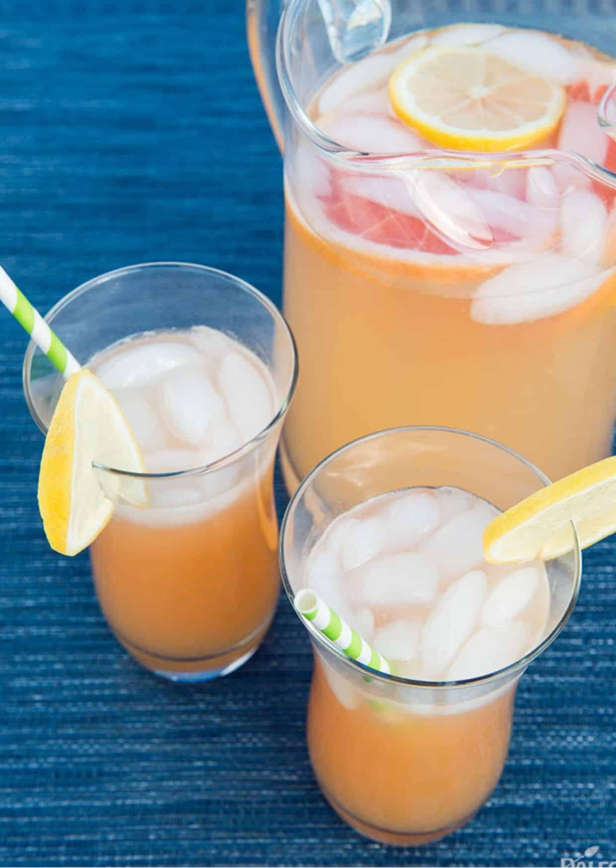 a pitcher of homemade grapefruit lemonade with slices of grapefruit and lemon