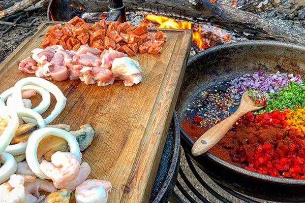 Ingredients laid out for Campfire Paella near a campsite