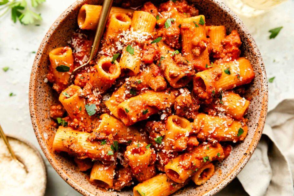 Close-up shot of bell pepper and sausage ragu simmering in a slow cooker