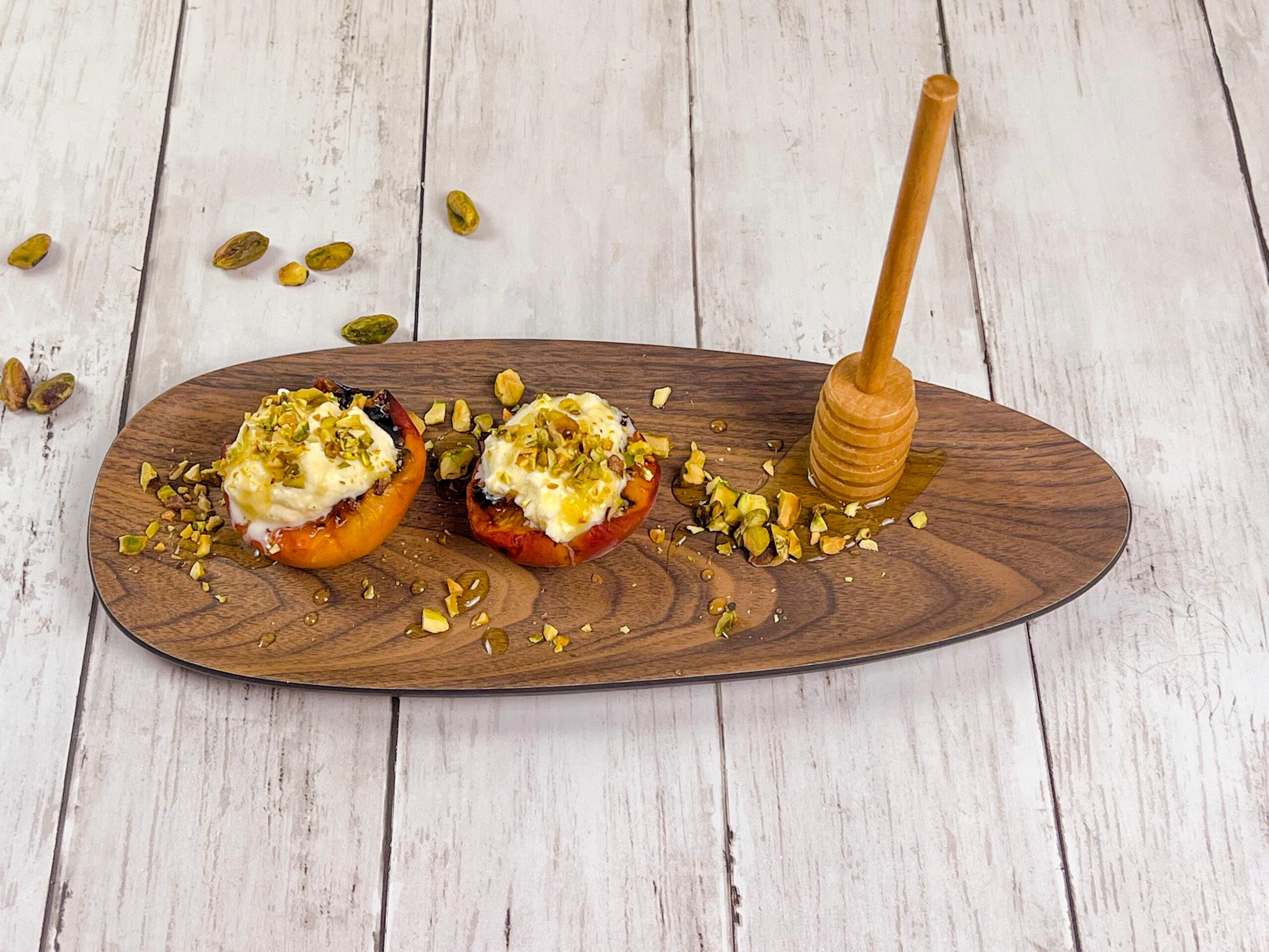 Overhead shot of a table setting with grilled apricots, mascarpone, and pistachios