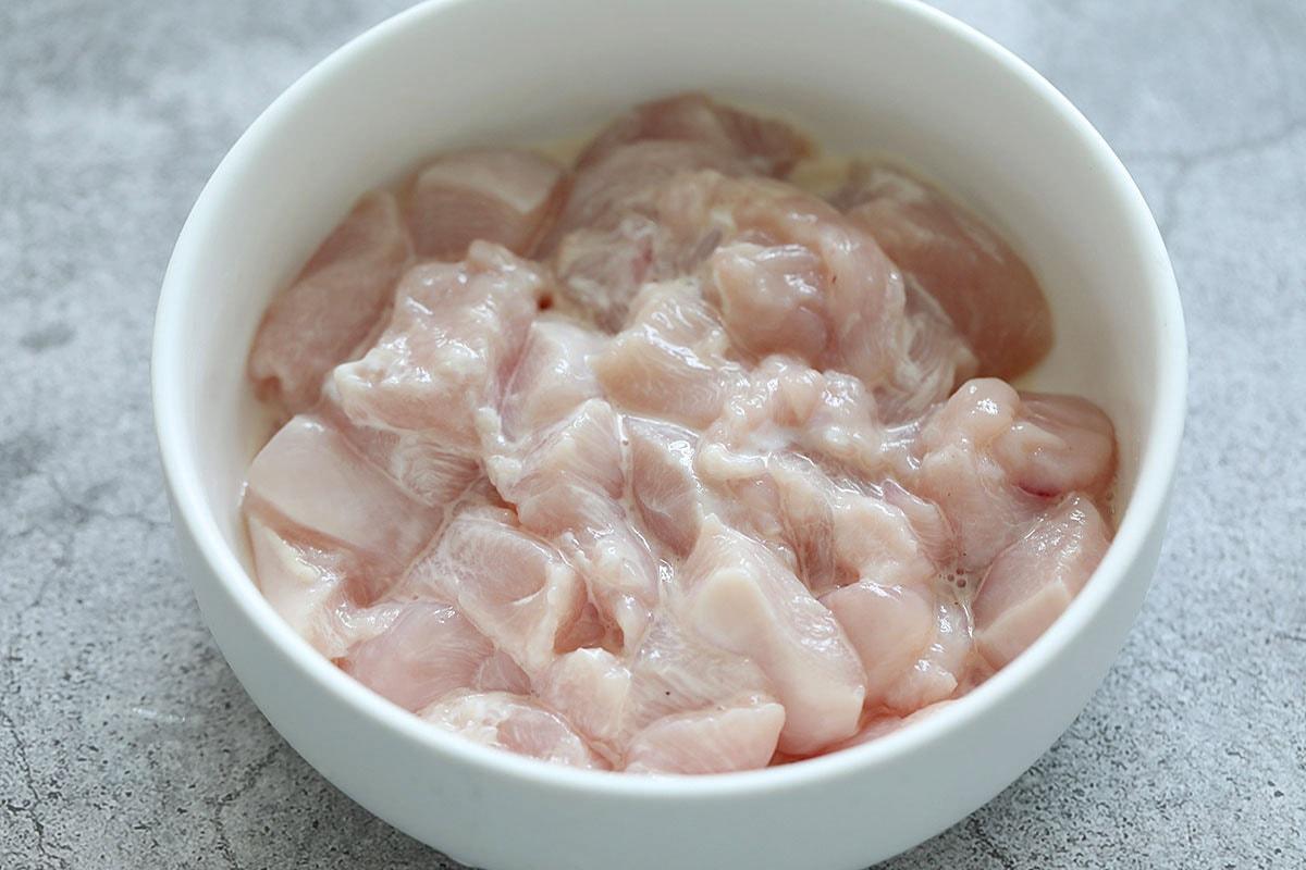 raw chicken marinating in Sichuan spices