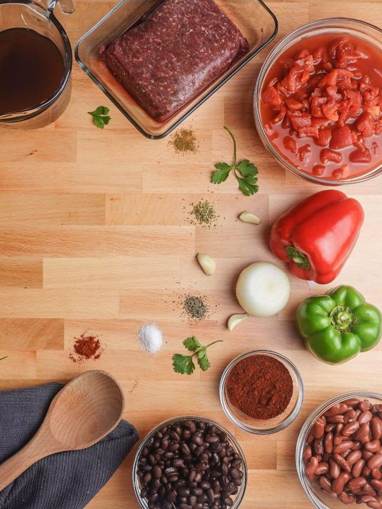 Ingredients for Ecuadorian chili laid out on a wooden table